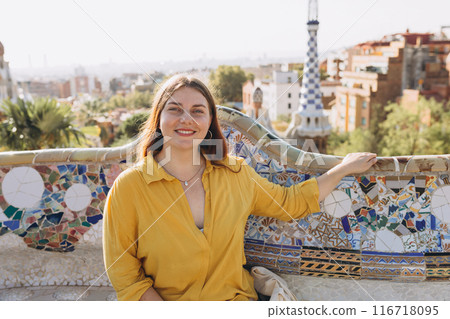 Woman 30s tourist having fun visiting famous Guell park in Barcelona. Concept of travel, tourism and vacation in city. Woman 30s tourist having fun visiting famous Guell park in Barcelona. Concept of travel, tourism and vacation in city. 116718095