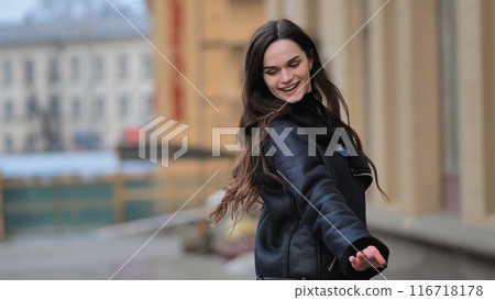 urban portrait of a stylish brunette girl in a black jacket urban portrait of a stylish brunette girl in a black jacket 116718178