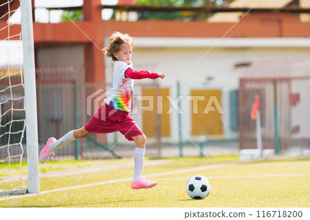 Child playing football. Kids play soccer. 116718200