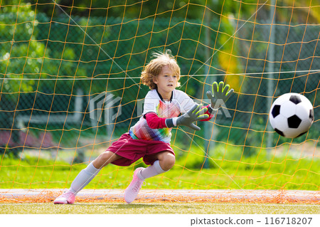Child playing football. Kids play soccer. Child playing football. Kids play soccer. 116718207
