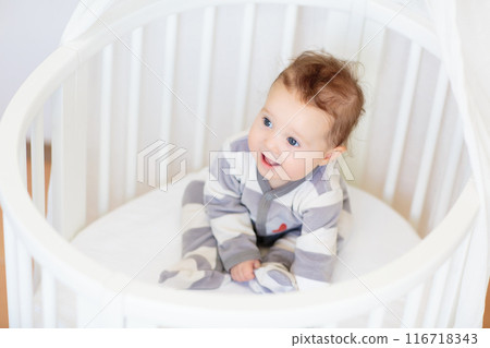 Little baby on white bed 116718343