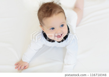 Little baby on white bed Little baby on white bed 116718348