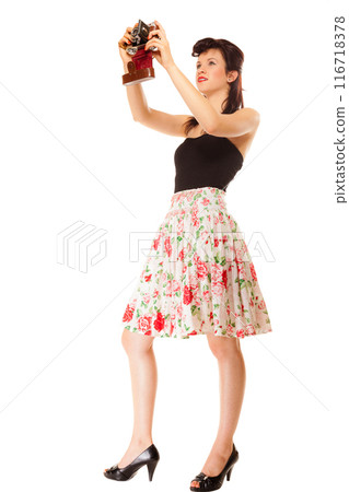 Girl taking self portrait from vintage camera Girl taking self portrait from vintage camera 116718378