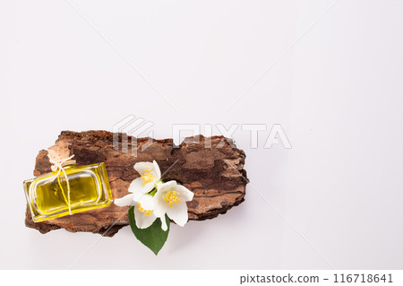 Jasmine flowers, bark and perfume bottle on white background. Flat lay. Copy space Jasmine flowers, bark and perfume bottle on white background. Flat lay. Copy space 116718641
