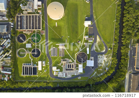 Aerial view of modern water cleaning facility at urban wastewater treatment plant. Purification process of removing undesirable chemicals, suspended solids and gases from contaminated liquid 116718917