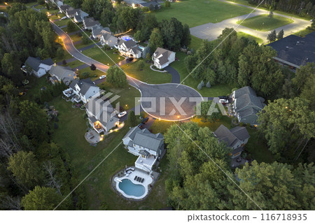 Aerial view of large private homes in Rochester, NY residential area at night. New family houses as example of real estate development in american suburbs Aerial view of large private homes in Rochester, NY residential area at night. New family houses as example of real estate development in american suburbs 116718935