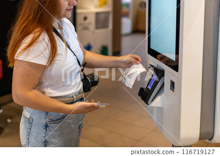 Woman Counter Buy electronic payment supermarket smartphone. Female hand with a mobile phone in pay for purchases in stores 116719127