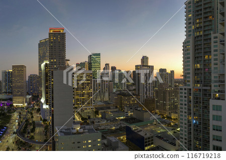 Aerial view of downtown office district of of Miami Brickell in Florida, USA at night. High commercial and residential skyscraper buildings in modern american megapolis Aerial view of downtown office district of of Miami Brickell in Florida, USA at night. High commercial and residential skyscraper buildings in modern american megapolis 116719218