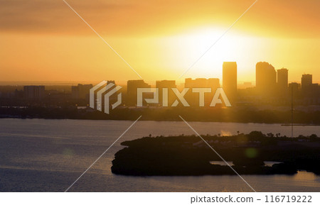 Aerial view of downtown district of Tampa city in Florida, USA at sunset. Dark silhouette of high skyscraper office buildings in modern american midtown 116719222