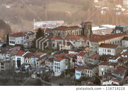 Aerial view of dense historic center of Thiers town in Puy-de-Dome department, Auvergne-Rhone-Alpes region in France. Rooftops of old buildings and narrow streets at sunset 116719228