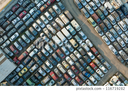 Aerial view of big parking lot of junkyard with rows of discarded broken cars. Recycling of old vehicles 116719282