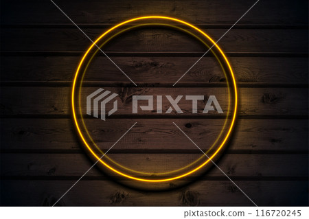 Orange neon luminous circle frame on dark brown wooden abstract background 116720245