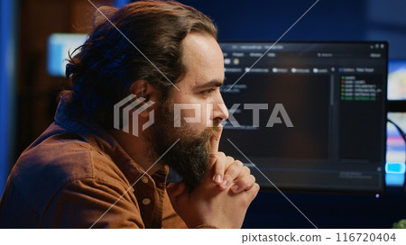 Cheerful software technician feeling satisfied after removing all bugs while coding on computer, close up. Smiling IT expert looking at screen, happy after solving script errors, camera A Cheerful software technician feeling satisfied after removing all bugs while coding on computer, close up. Smiling IT expert looking at screen, happy after solving script errors, camera A 116720404