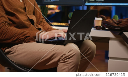 Remote programmer starting job shift in personal office at home, taking laptop out of bag. Teleworker unpacking backpack, writing lines of code on notebook keyboard, camera A close up Remote programmer starting job shift in personal office at home, taking laptop out of bag. Teleworker unpacking backpack, writing lines of code on notebook keyboard, camera A close up 116720415