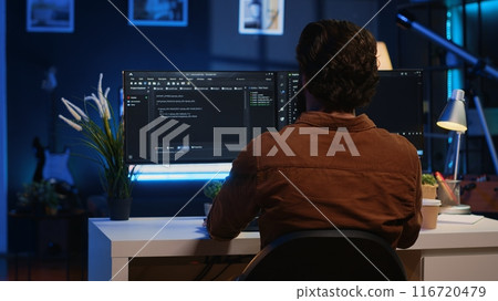Remote software developer arriving in personal office at home, starting job shift with cup of coffee. Teleworker enjoying hot beverage while writing lines of code on computer, camera A 116720479