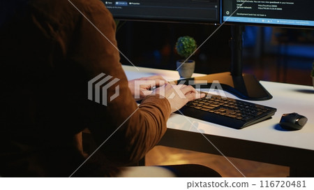 Software developer impatiently spamming malfunctioning keyboard buttons, trying to write lines of code in home office. Irritated IT professional having trouble with computer peripheral, close up 116720481