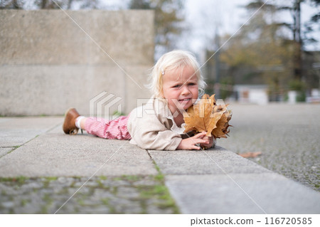 Portrait of two years old baby girl crying outdoors. fell down Portrait of two years old baby girl crying outdoors. fell down 116720585