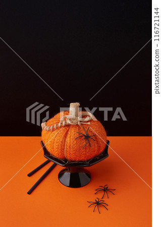 Autumn handmade textile decoration on orange table. Cozy fabric pumpkin. Halloween decor. Autumn handmade textile decoration on orange table. Cozy fabric pumpkin. Halloween decor. 116721144