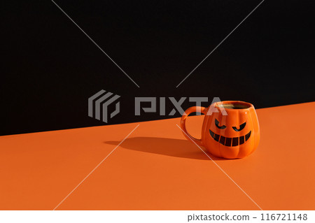 Cappuccino latte coffee in pumpkin cup on black orange background. Halloween celebration concept 116721148