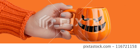 Cappuccino latte coffee in pumpkin cup on orange background. Halloween celebration concept 116721158