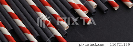 Black and red paper straws on black background. Halloween celebration party Black and red paper straws on black background. Halloween celebration party 116721159