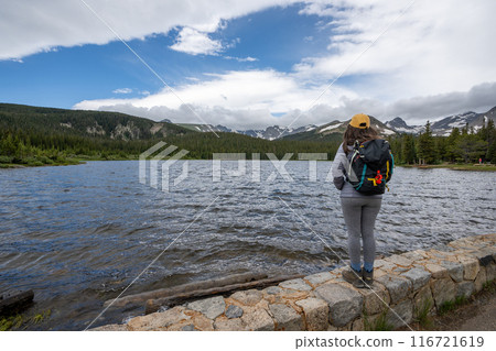 Woman enjoys view of Brainard Lake, Colorado under dramatic summer cloudscape Woman enjoys view of Brainard Lake, Colorado under dramatic summer cloudscape 116721619