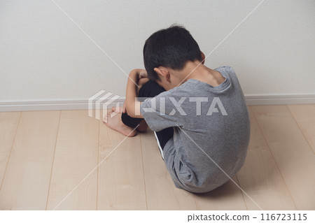 Boy holding his knees and drooping 116723115