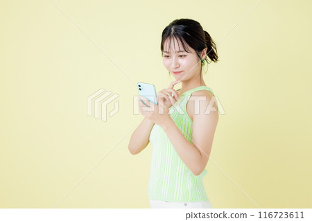 Lifestyle A woman looking at a smartphone 116723611