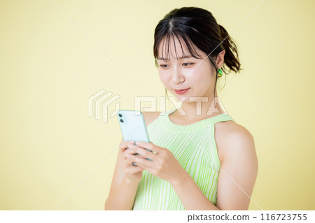 Lifestyle A woman looking at a smartphone Lifestyle A woman looking at a smartphone 116723755