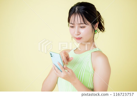 Lifestyle A woman looking at a smartphone 116723757