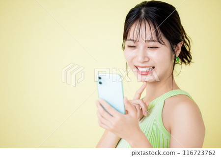 Lifestyle A woman looking at a smartphone Lifestyle A woman looking at a smartphone 116723762