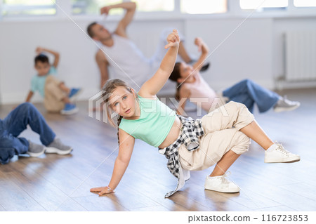 Girls and boys training hip hop in dance studio, dance classes for kids Girls and boys training hip hop in dance studio, dance classes for kids 116723853