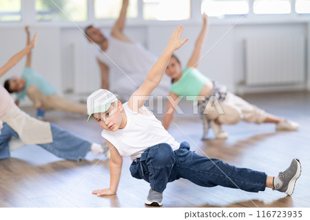 Preteen boy honing hip hop dance moves in choreographic studio Preteen boy honing hip hop dance moves in choreographic studio 116723935