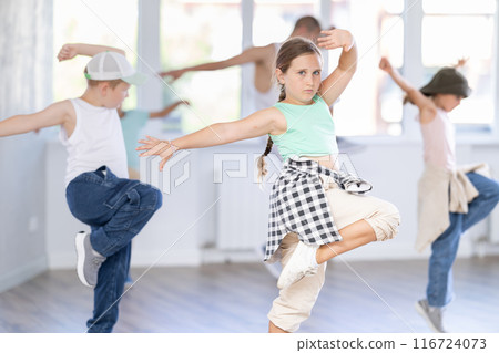 Girls and boys training hip hop in dance studio, dance classes for kids Girls and boys training hip hop in dance studio, dance classes for kids 116724073