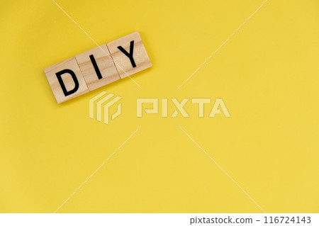 DIY Do It Yourself inscription on yellow background. Handmade home repair decorating handicraft. Tactile creative hobby concept 116724143