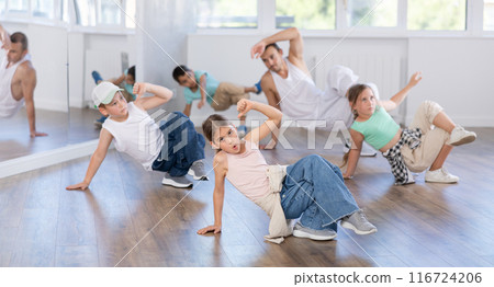 Preteen girl performing hip hop in group class for kids 116724206