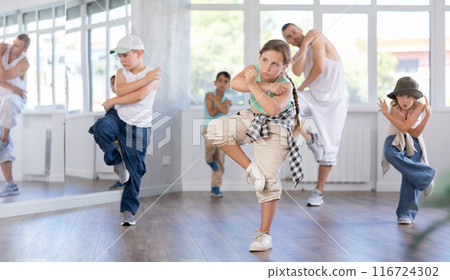 Preteen girl honing hip hop dance in choreographic studio Preteen girl honing hip hop dance in choreographic studio 116724302