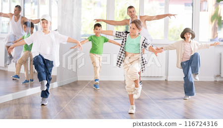 Girls and boys performing hip hop dance training hall during group dancing classes 116724316