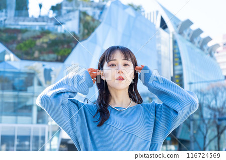 Portrait of a young woman with a building in the background Portrait of a young woman with a building in the background 116724569
