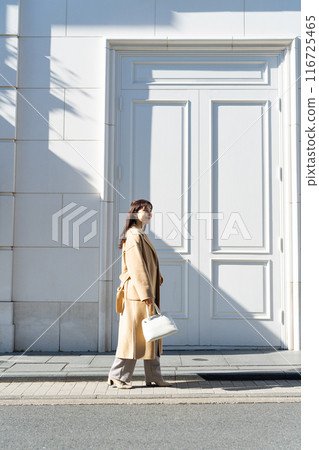 Young woman walking outdoors 116725465