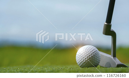 Golf clubs and balls on a green lawn in a beautiful golf course with morning sunshine. Golf clubs and balls on a green lawn in a beautiful golf course with morning sunshine. 116726160