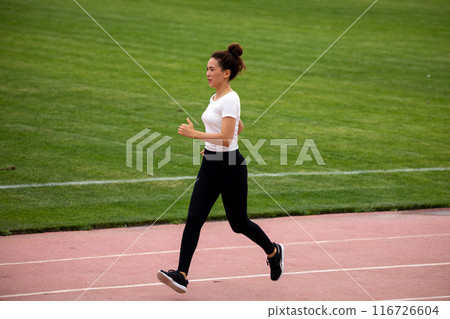 Beautiful curly Asian woman running on the street Beautiful curly Asian woman running on the street 116726604