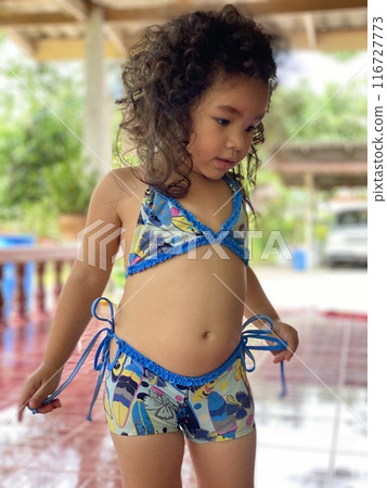 Portrait of cute Asian little girl wearing a blue swimsuit Portrait of cute Asian little girl wearing a blue swimsuit 116727773