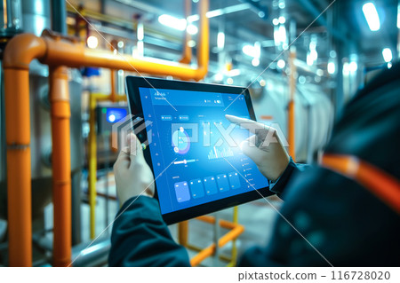 An engineer uses a tablet to control smart factory automation software. The concept of modern technology streamlining industrial process through digital tools and automation. Generative AI. 116728020