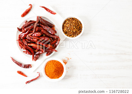 Dried red chilies on white wooden table. Dried red chilies on white wooden table. 116728022