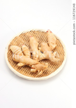Fresh ginger in a colander Fresh ginger in a colander 116729148