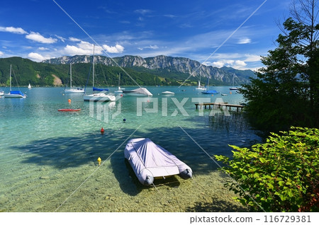 Attersee - a beautiful blue lake in Austria. Surrounded by mountains and green forests. Regions with nature in the Alps. A great place for sports, recreation and outdoor activity holidays. 116729381