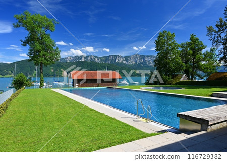 Attersee - a beautiful blue lake in Austria. Surrounded by mountains and green forests. Regions with nature in the Alps. A great place for sports, recreation and outdoor activity holidays. 116729382