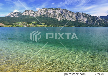 Attersee - a beautiful blue lake in Austria. Surrounded by mountains and green forests. Regions with nature in the Alps. A great place for sports, recreation and outdoor activity holidays. 116729383