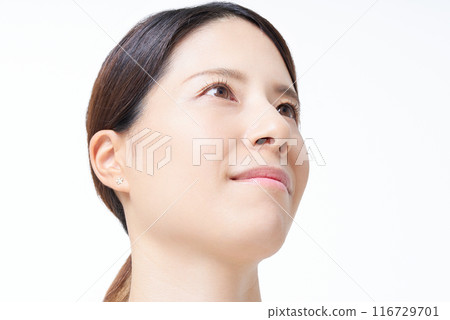 A woman in a tank top standing in front of a white background 116729701